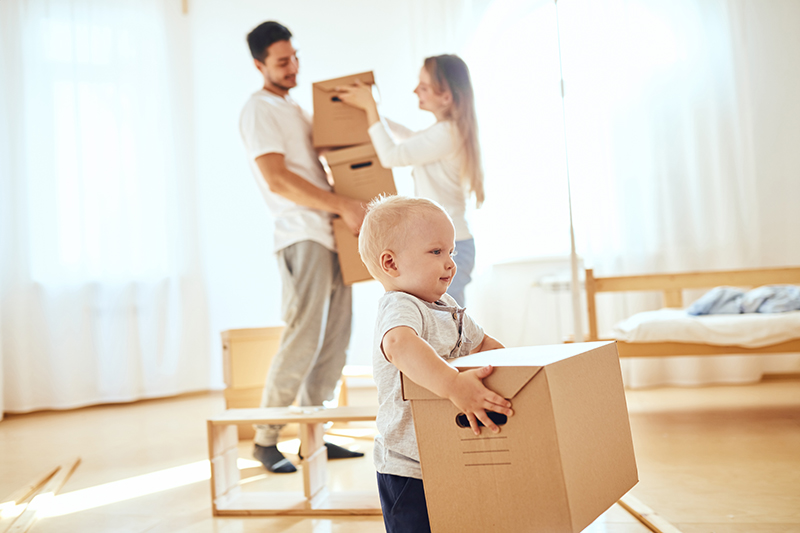 Family moving carrying boxes - Move-in/Move-out Cleanings by Bee Natural Cleaning